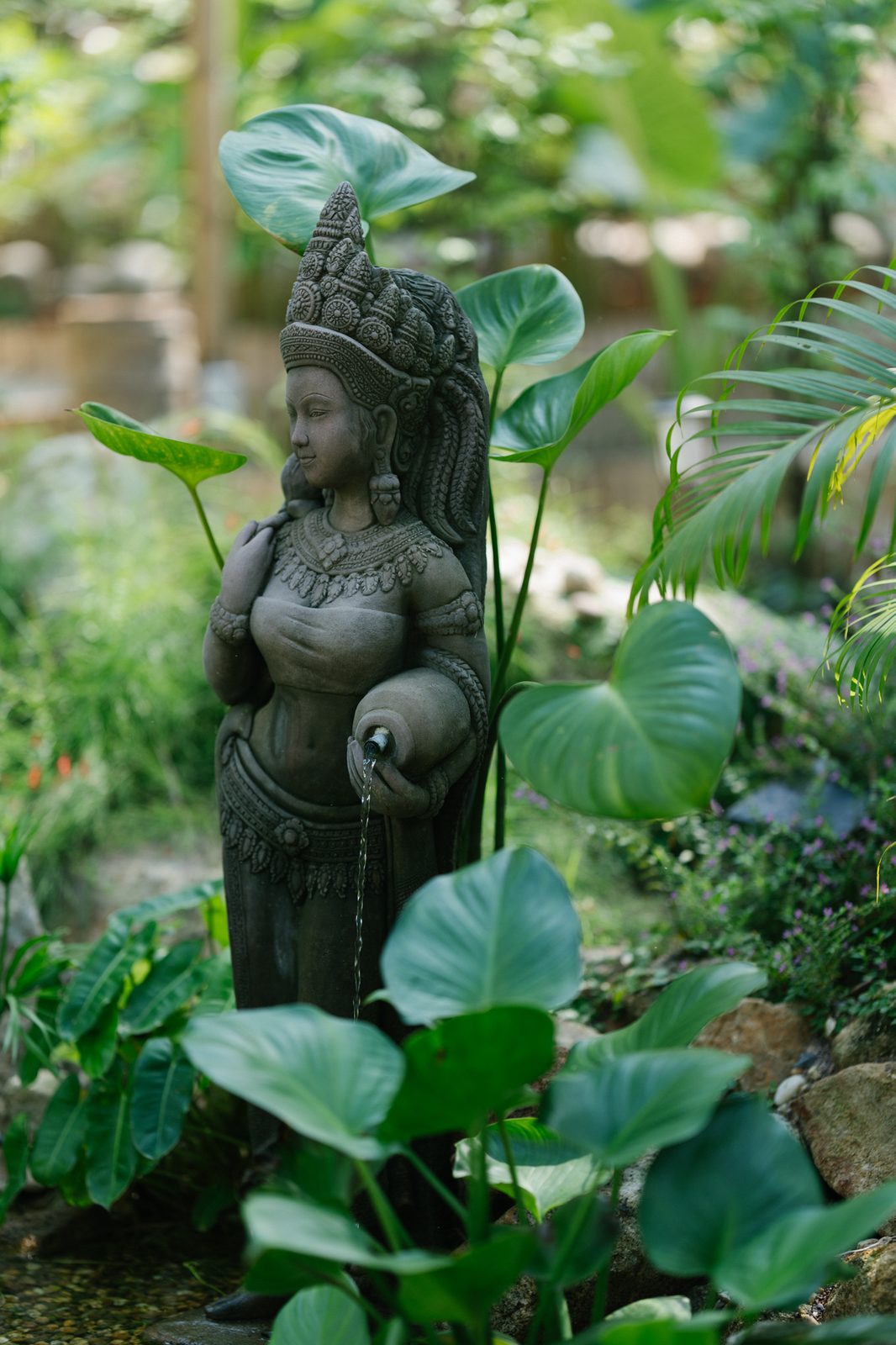Thai statue water feature among the gardens